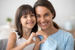 about lovett dental katy, mother and daughter making heart hands