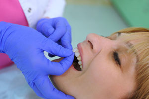 dental veneers tx, woman getting veneers applied