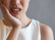 how to prevent tooth decay, close of woman holding side of her jaw