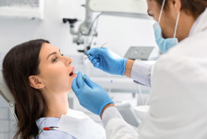 woman in dentist chair getting dental fillings and sealants katy tx