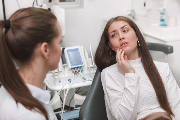 What-Are-Emergency-Dental-Services- woman needing emergency dental services