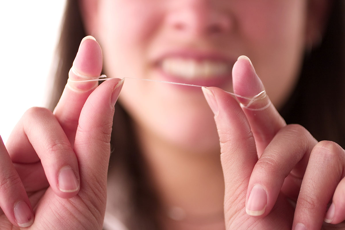 a woman learning about the benefits of flossing daily