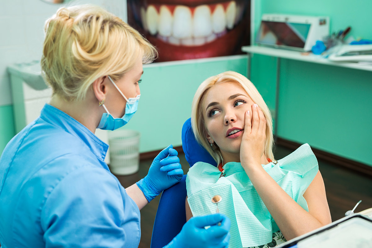 woman in dentist chair learning what is a dental emergency