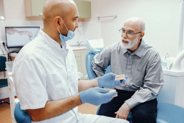 specialty-dentistry dentist explaining specialty dentistry to patient