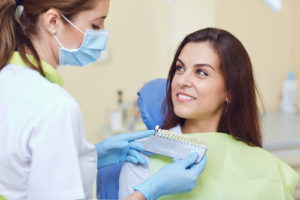 doctor preps patient for a dental crown