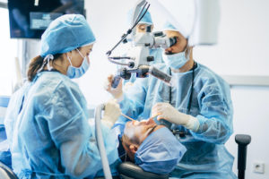 doctors perform a tooth extraction on a patient 