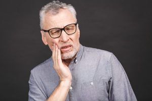 man struggles with teeth grinding 