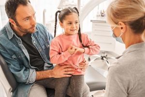 dad and daughter learning about family dentistry